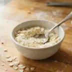 A small bowl of instant potato flakes with a spoon