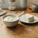 A small bowl of silken tofu blended smooth, beside a soft block of silken tofu